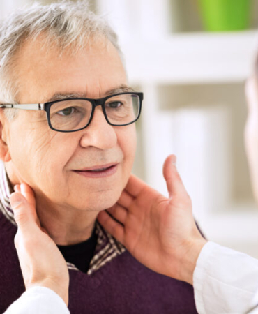 Doctor,Examining,Old,Patient,Lymph,Glands,,Throat,Inflammation