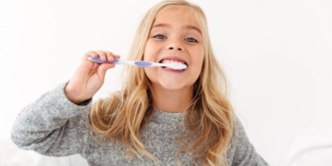 close-up-portrait-cute-kid-gray-pajamas-brushing-her-teeth-min-768x512