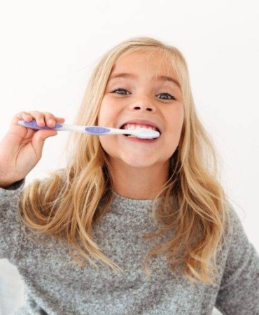 close-up-portrait-cute-kid-gray-pajamas-brushing-her-teeth-min-768x512
